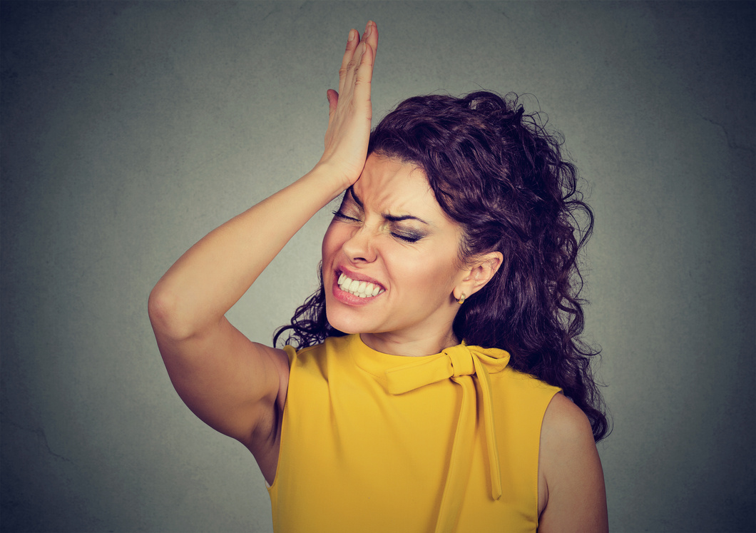 woman, slapping hand on head having duh moment